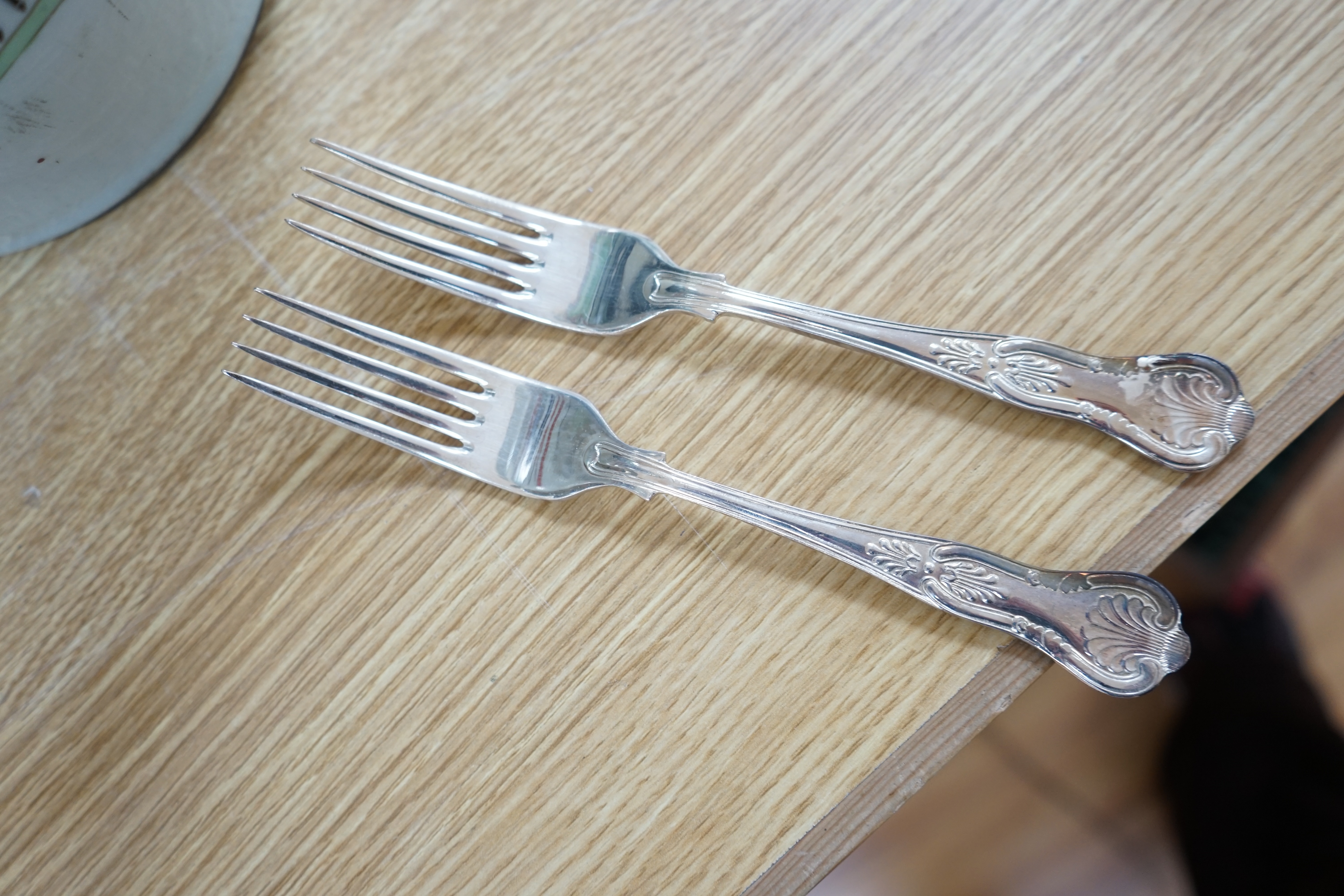 A walnut cased canteen of cutlery with drawer, retailed by Harrods. Condition - one dessert spoon missing